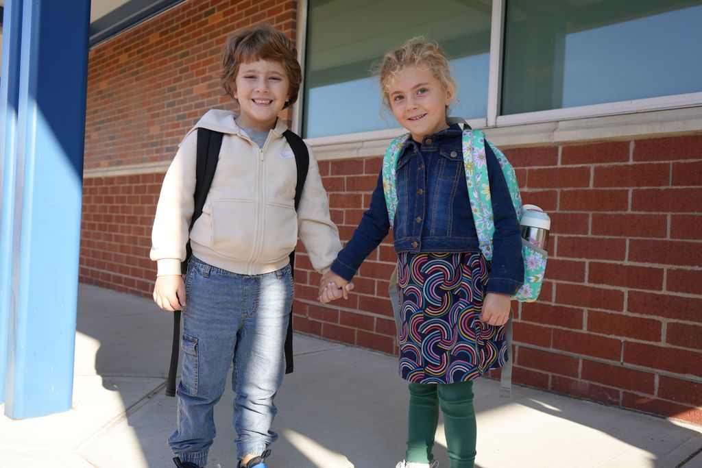 friends smiling together before entering school