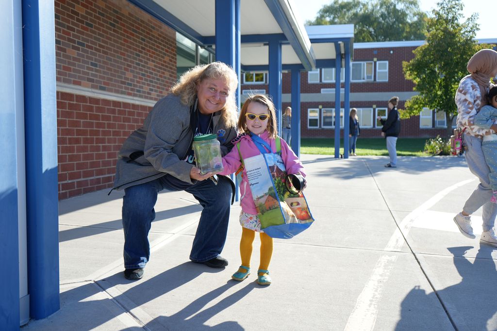 student and principal smiling 