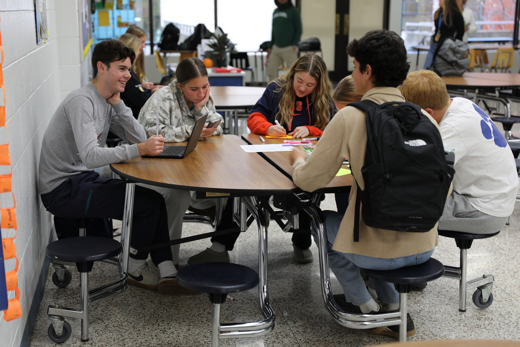 a group of students working on their notecards