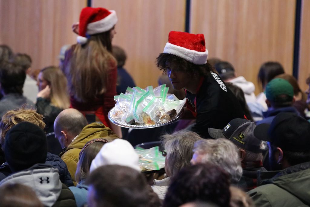 One of the student staff members handing out cookies at the show