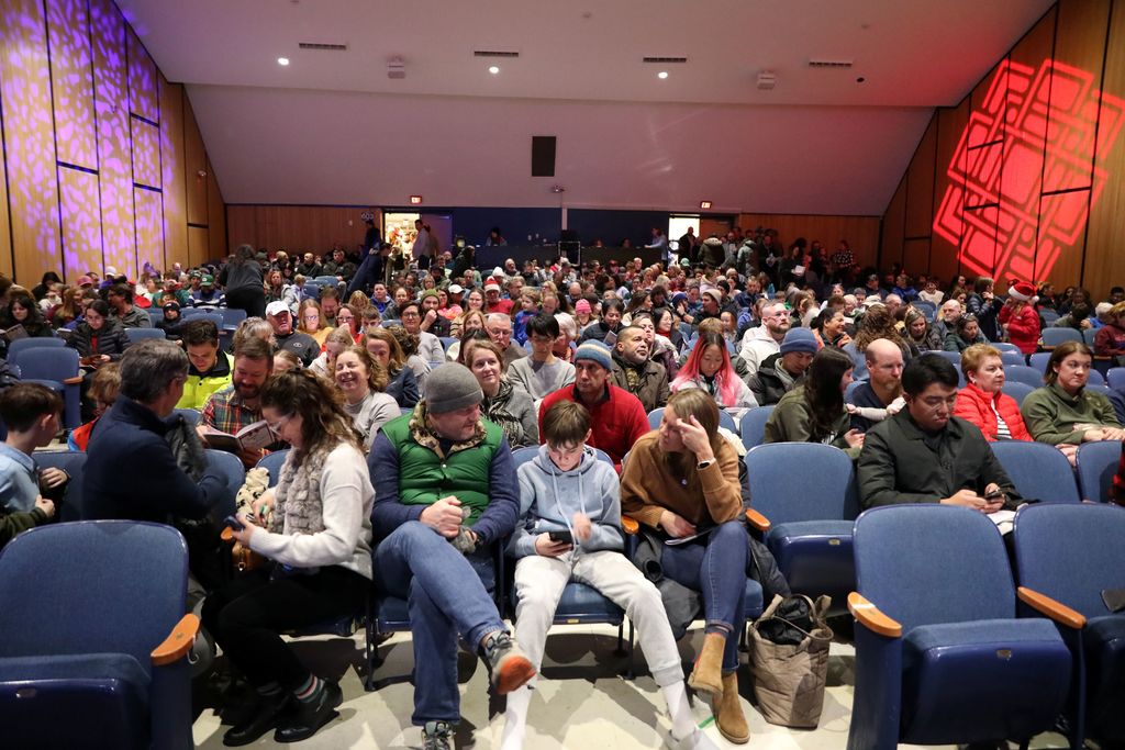A full house auditorium with almost every seat full