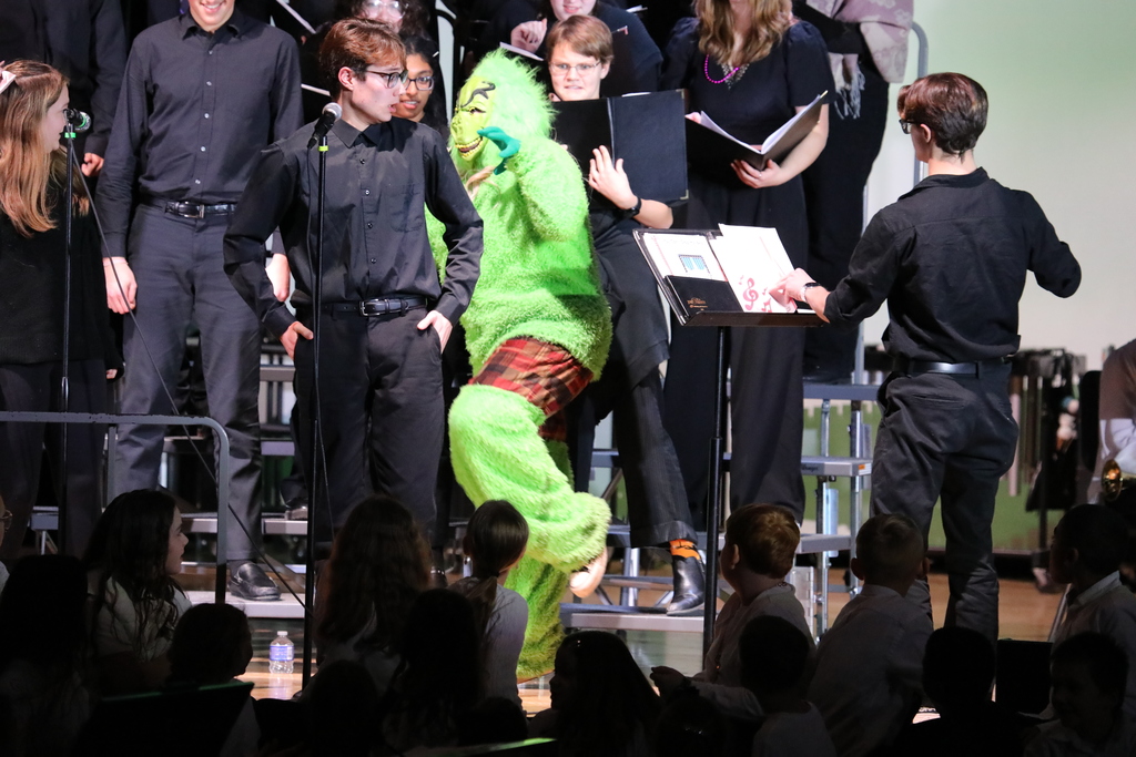 A grinch showing up and scaring the choir 