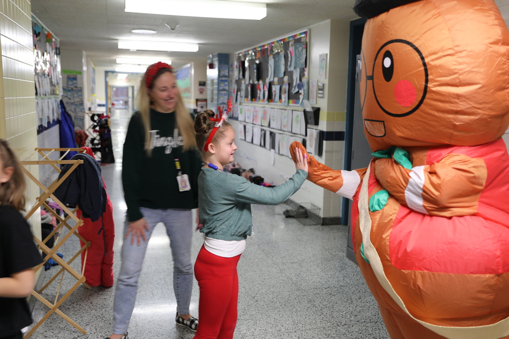the gingerbread man giving a highfive to a student