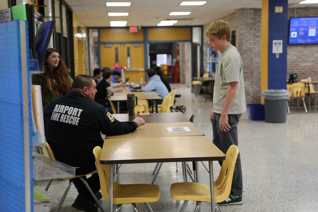 A student having a discussion with the Fire Chief about career possibilities