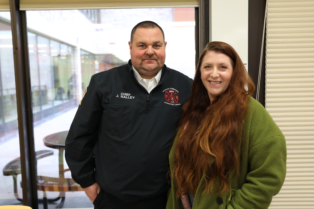 The Fire Chief and a staff member posing for a photo, smiling at camera
