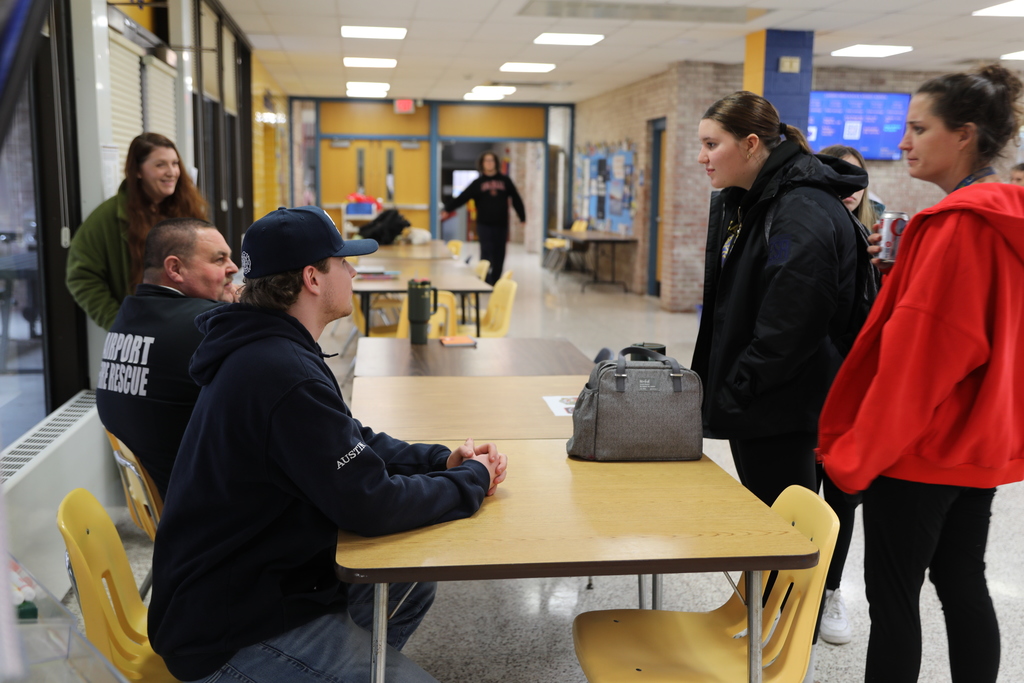 A few students having a discussion with the Fire Chief about career possibilities