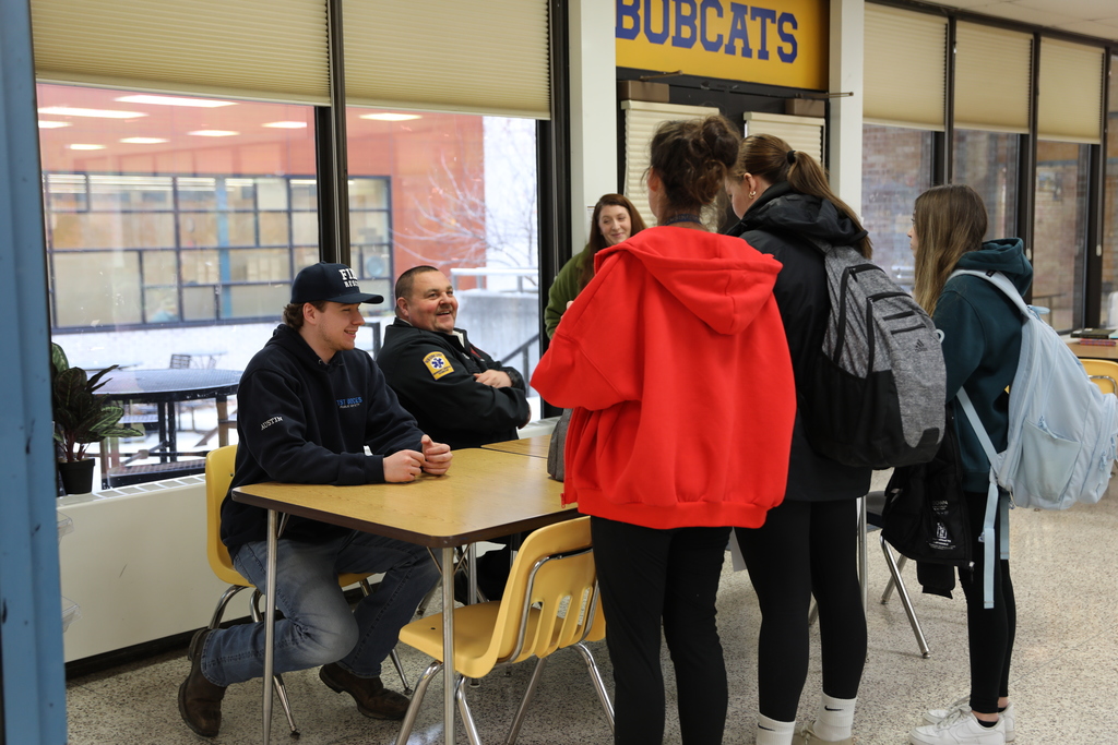 A few students having a discussion with the Fire Chief about career possibilities