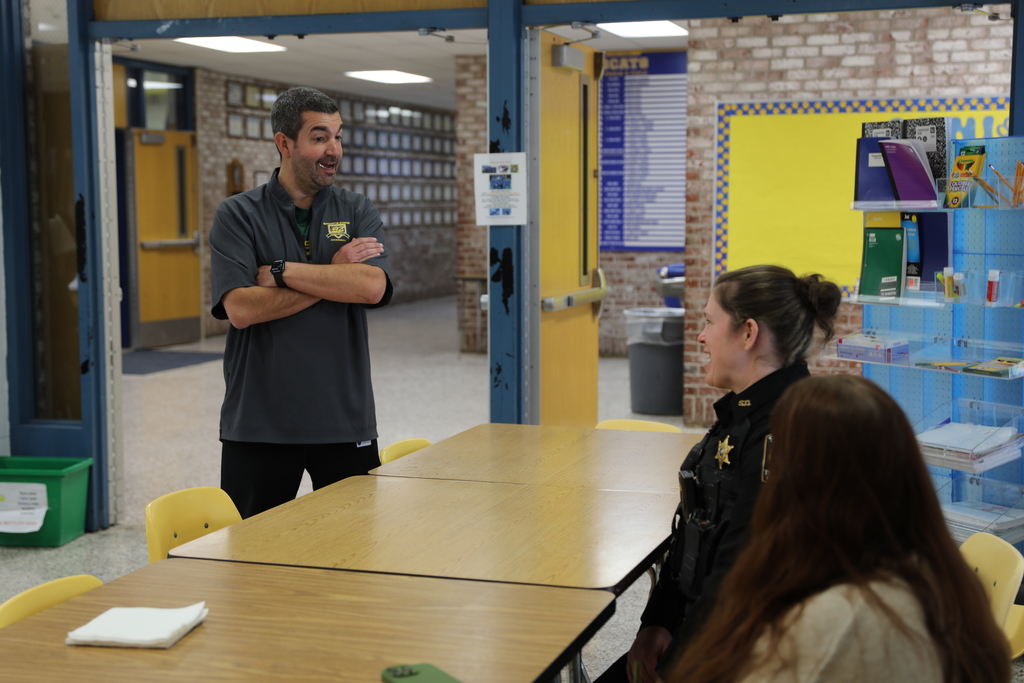 A Sheriff's deputy speaking with a staff member