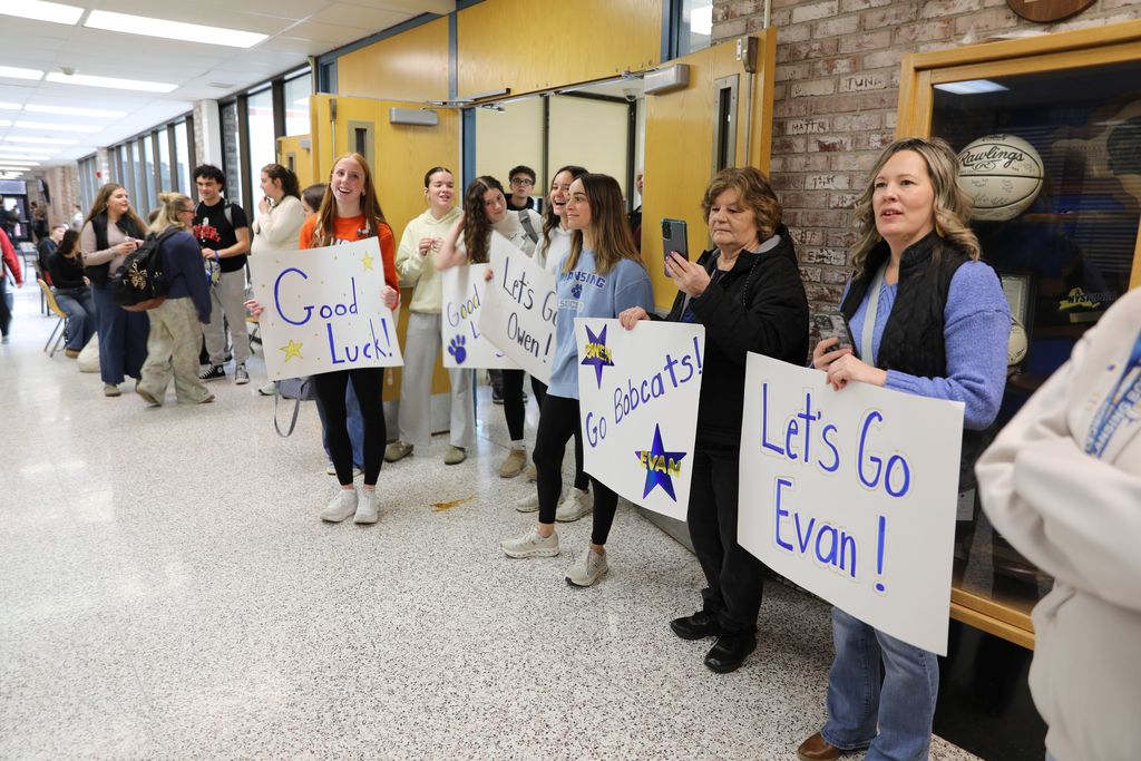 A hallway filled with people celebrating the send-off