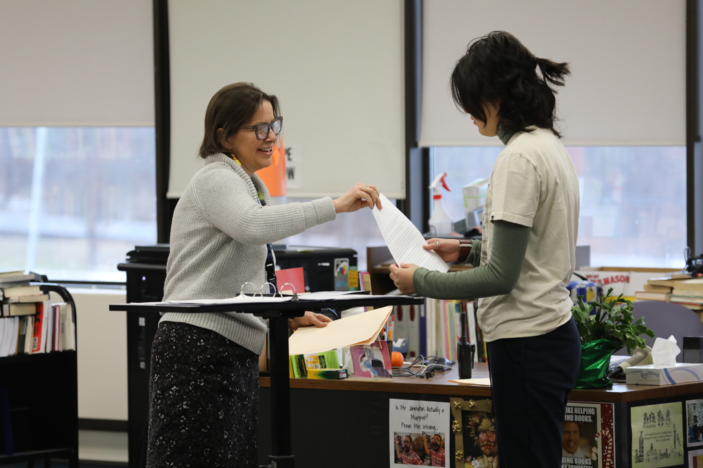 a teacher handing a student an award