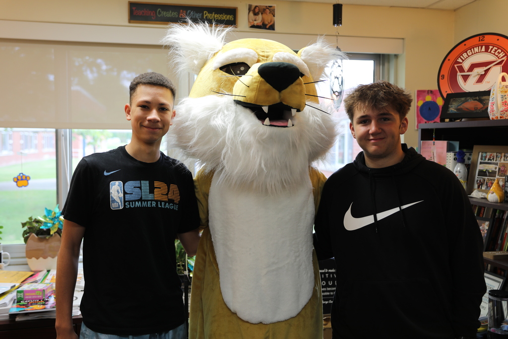 The Bobcat posing with two students who helped the Bobcat around the school