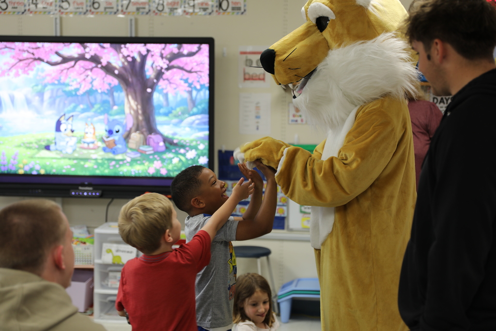 some students giving high fives to the Bobcat