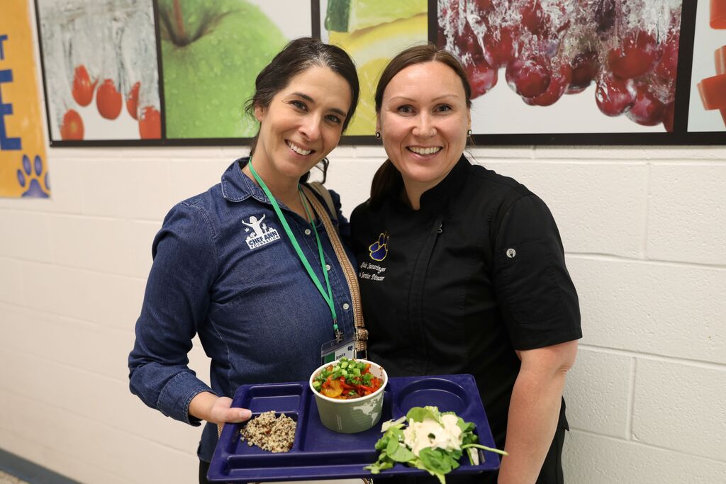 two people posing for the camera and smiling