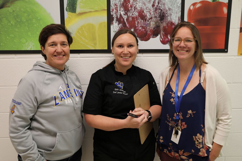 Three Lansing staff members posing for the camera