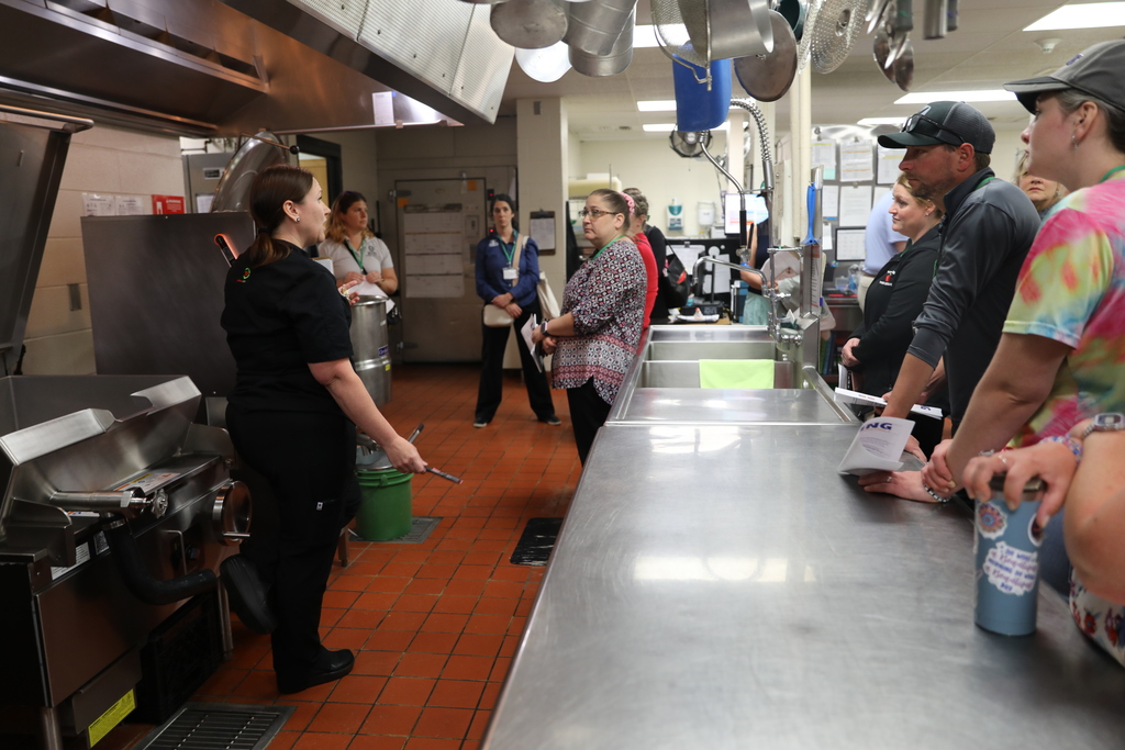 a group of people being shown the kitchen at Lansing