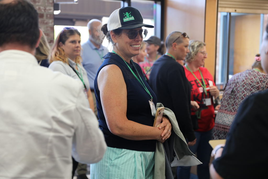 A group of people entering into Lansing school and smiling