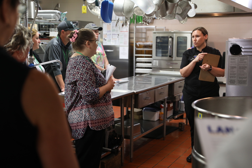 A group of people being shown parts of the kitchen at Lansing