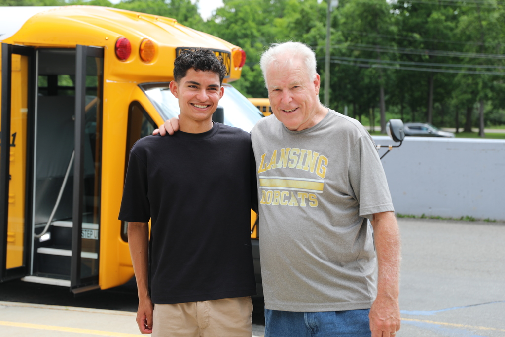 a student and staff or parent posing for a photo