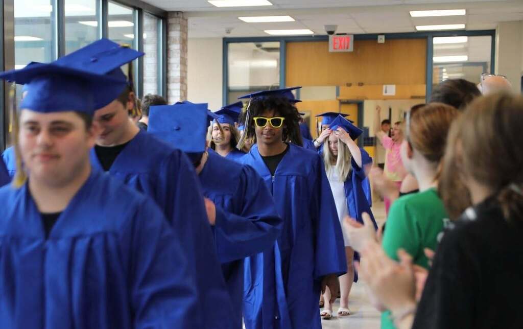 Seniors walking the halls as people cheer them on