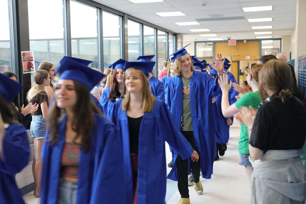 Seniors walking the halls as people cheer them on