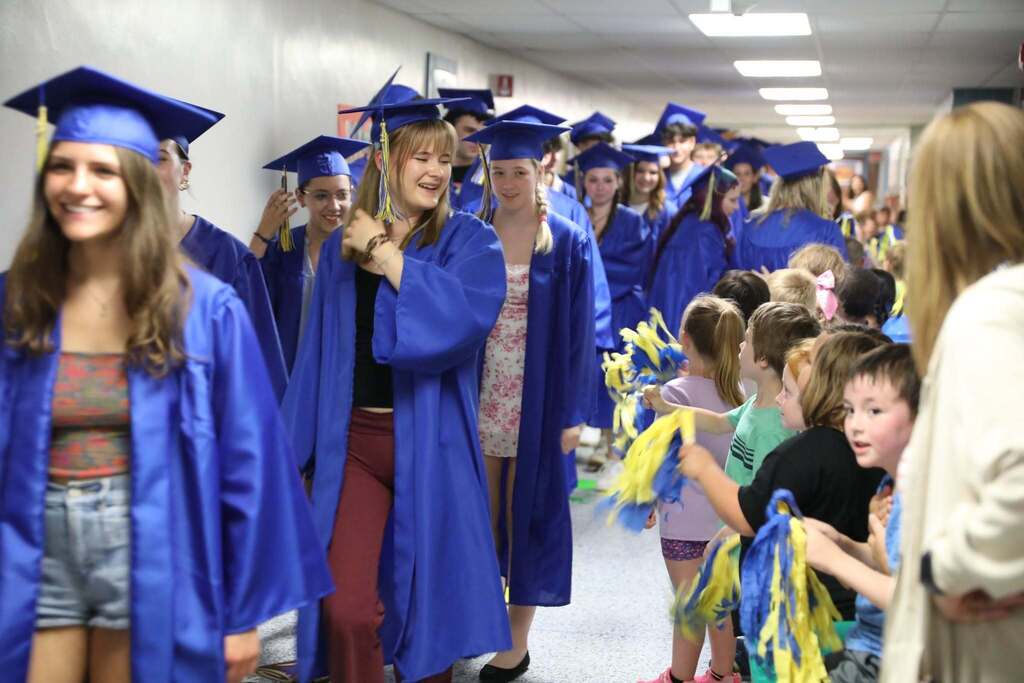 Seniors walking the halls as people cheer them on