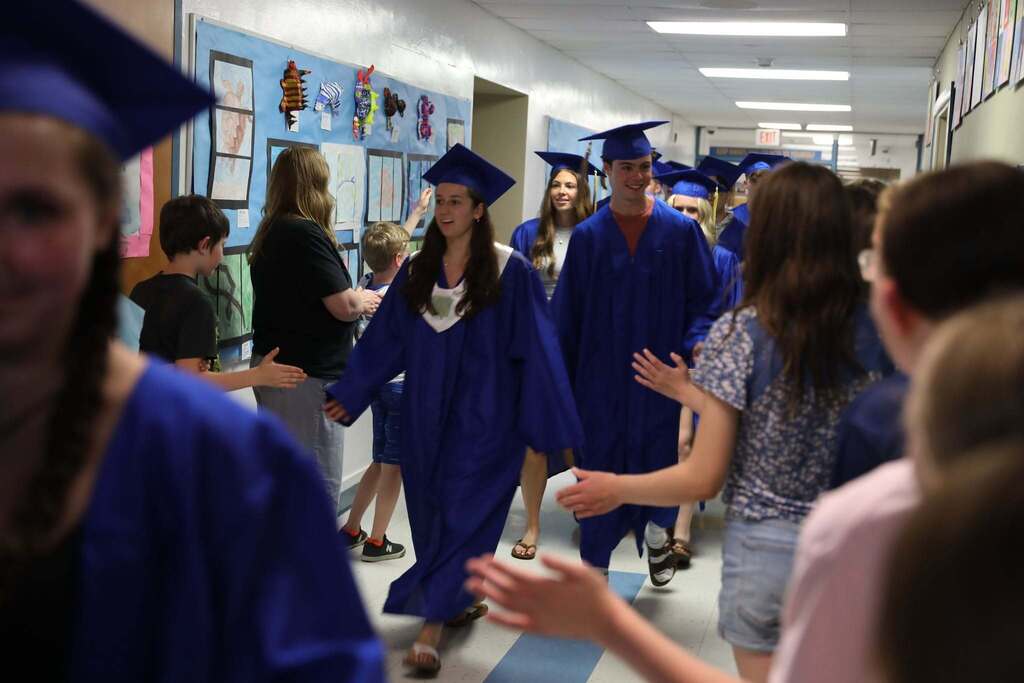 Seniors walking the halls as people cheer them on