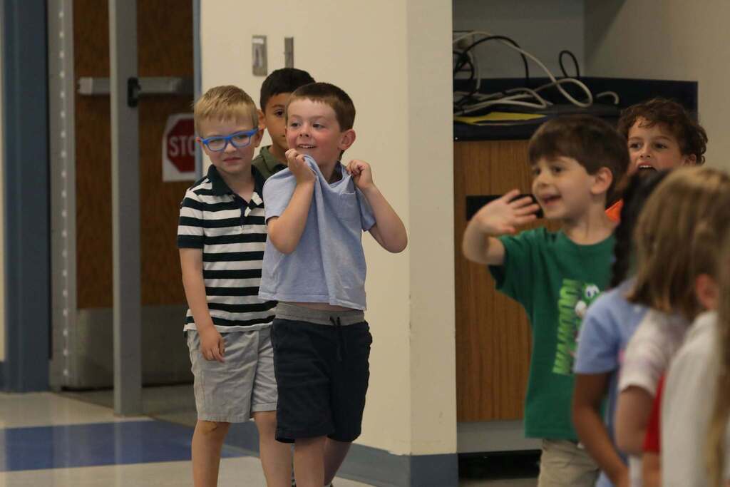 a group of PreK students walking into the room