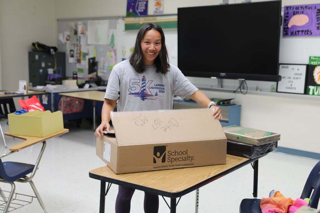 a staff member opening a box