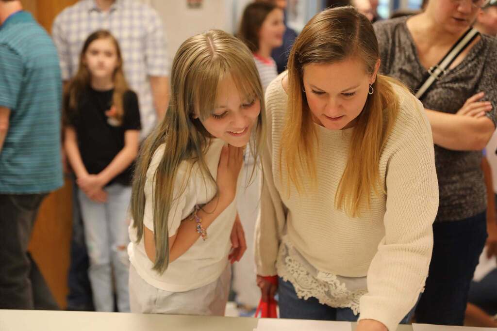 a parent and a student looking at their classroom schedule