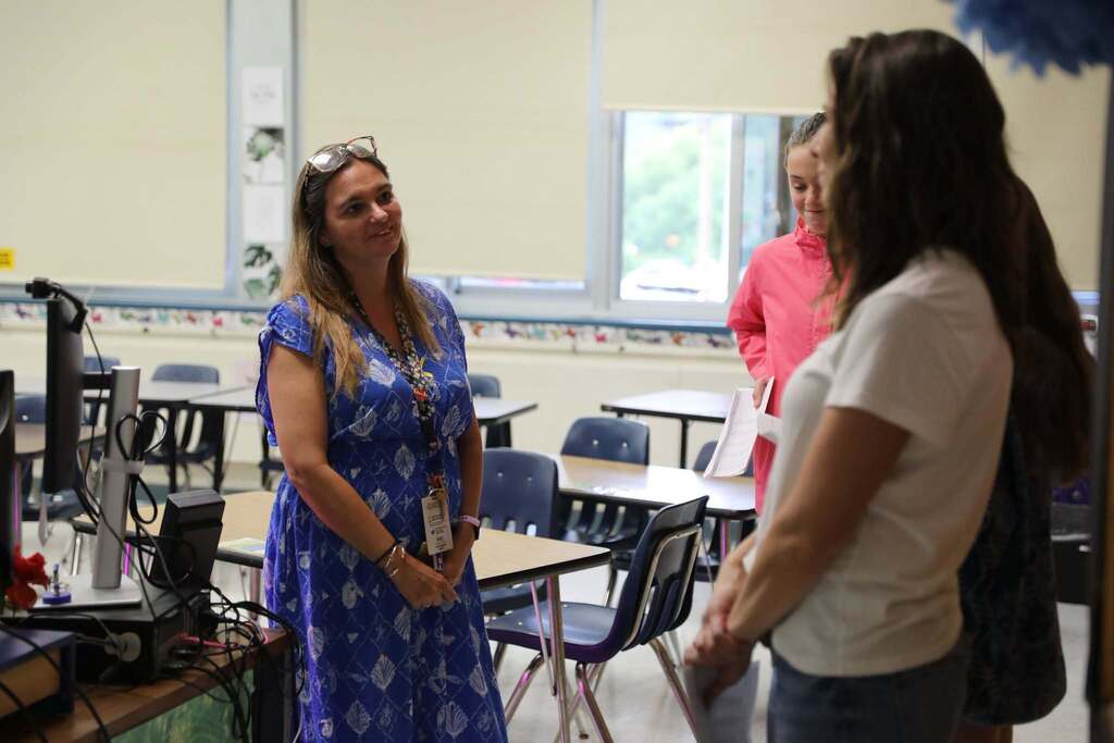 a teacher speaking with a family