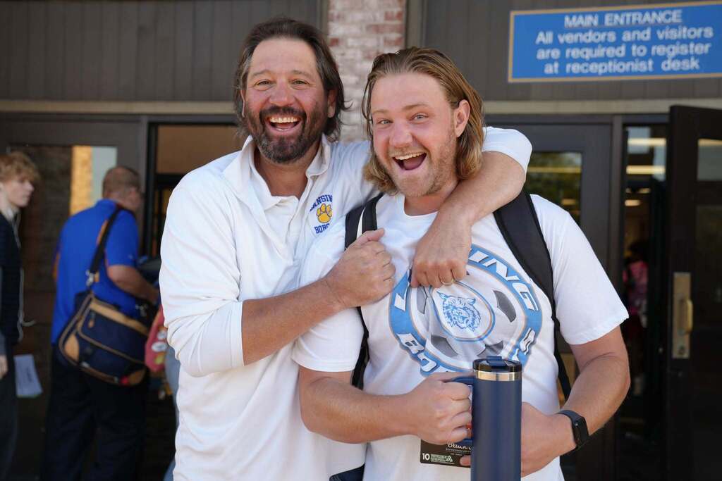 the principal making a funny face with a student
