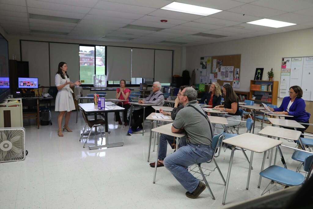 a teacher speaking to a room of parents