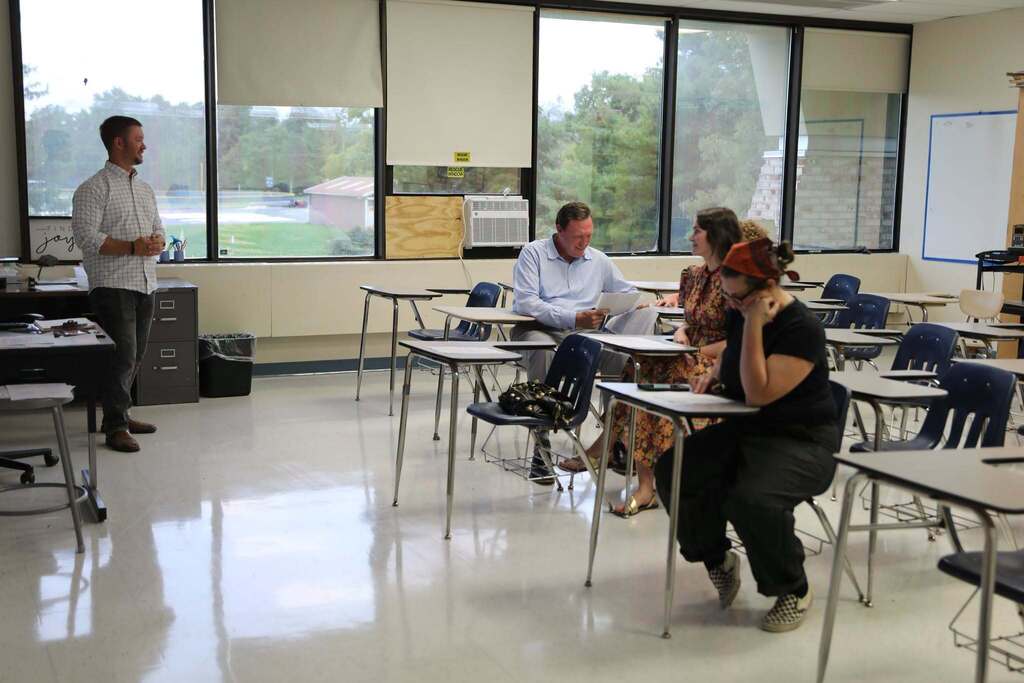 a teacher talking to a room of parents