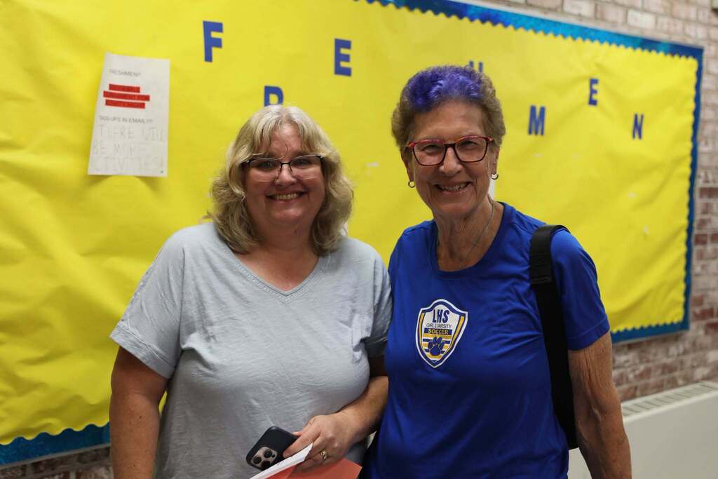 two staff members posing for a photo