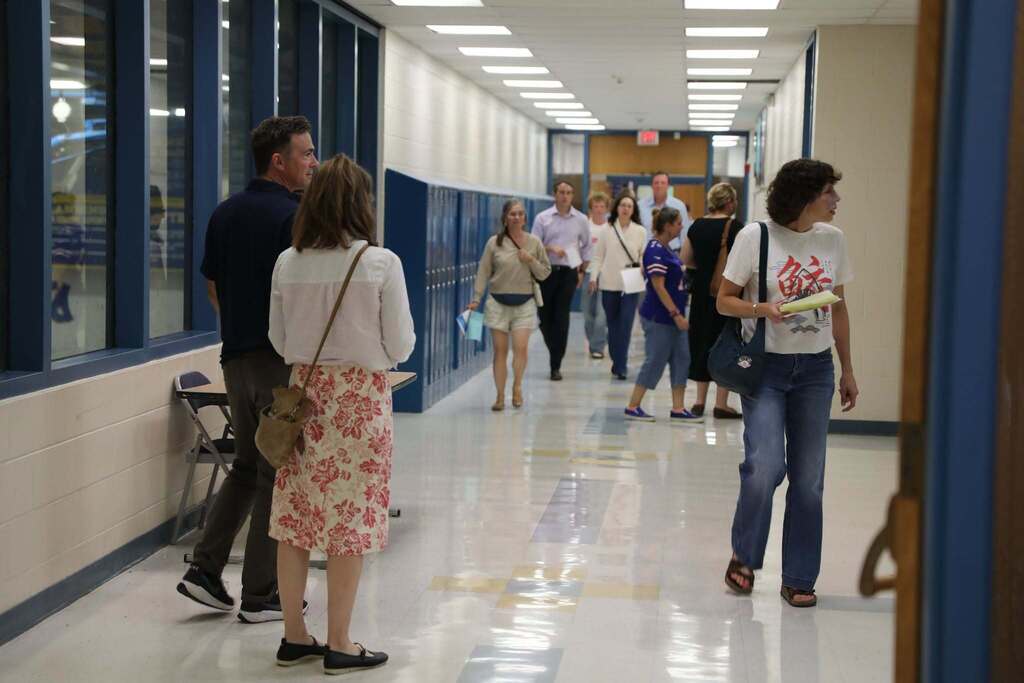 a hallway full of parents walking