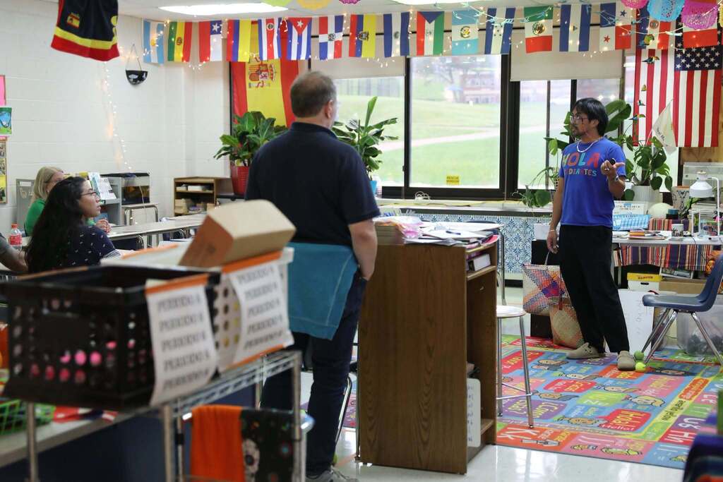 a teacher speaking with a room of parents