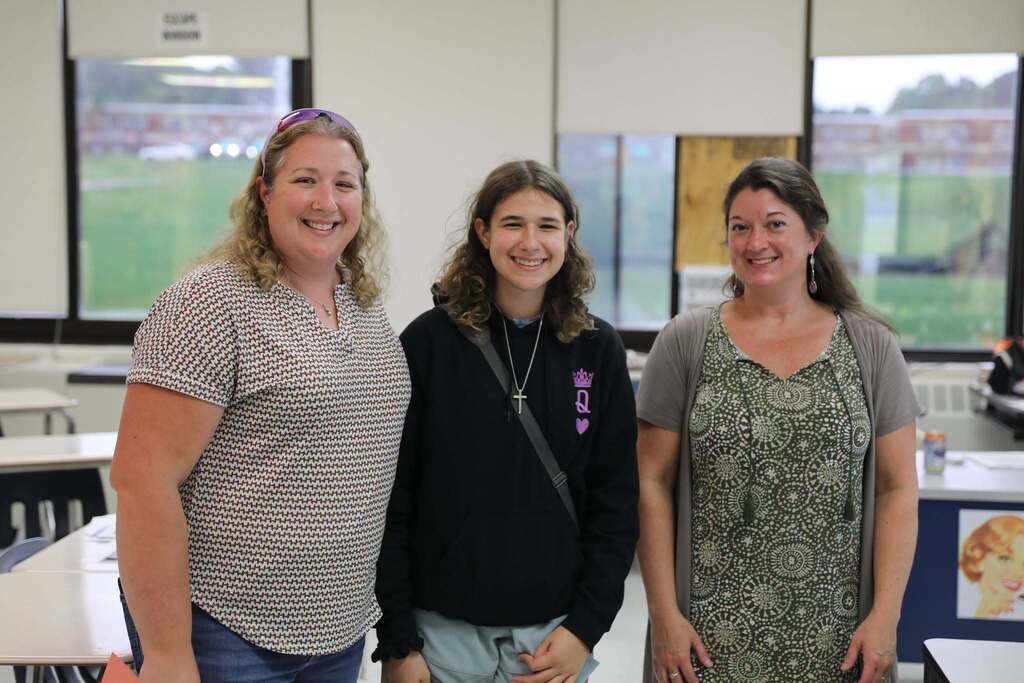 a family and teacher posing for the camera