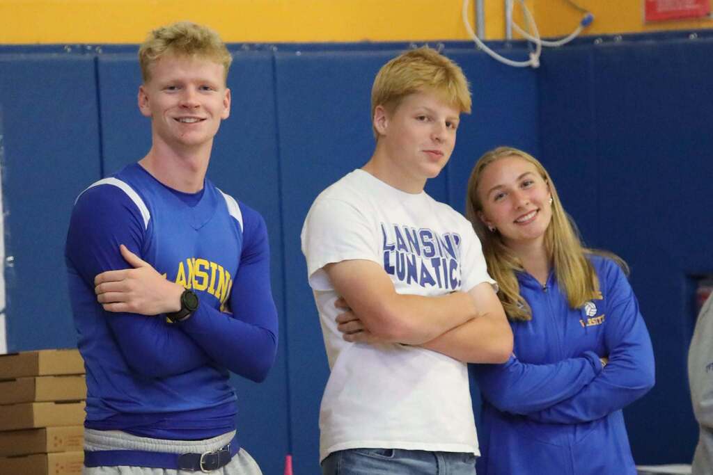 three students looking at the camera for a picture