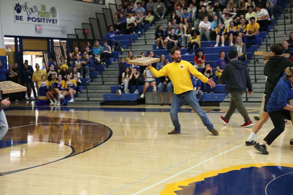 the principal of the high scool defending his pizza box from getting knocked over
