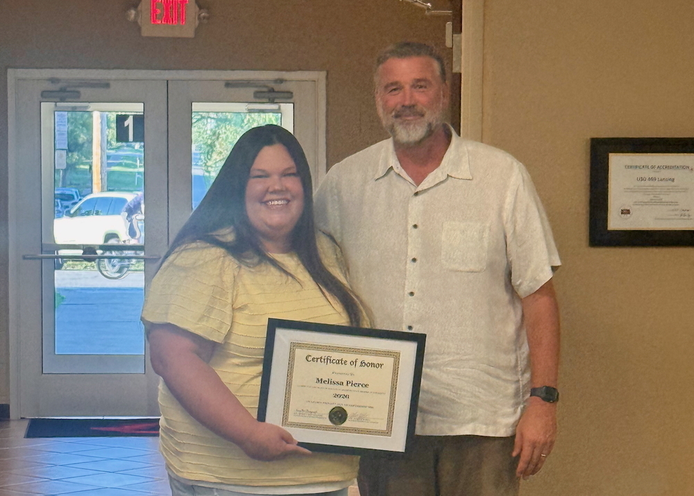 Melissa Pierce with principal Chad Eshbaugh holding certiticate