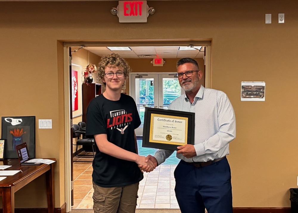 Matthew Bone receiving certificate for student of the month