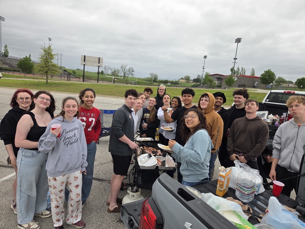 Students at Lansing High School eating breakfast in parking lot