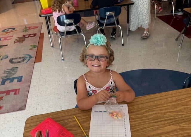 First Graders at their desks in a classroom