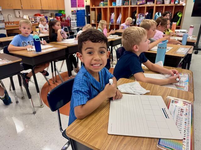 First Graders at their desks in a classroom