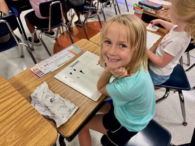 First Graders at their desks in a classroom