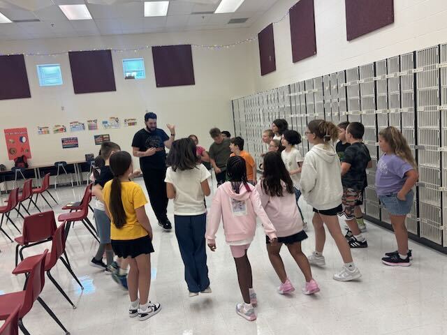Students in music class with their teacher