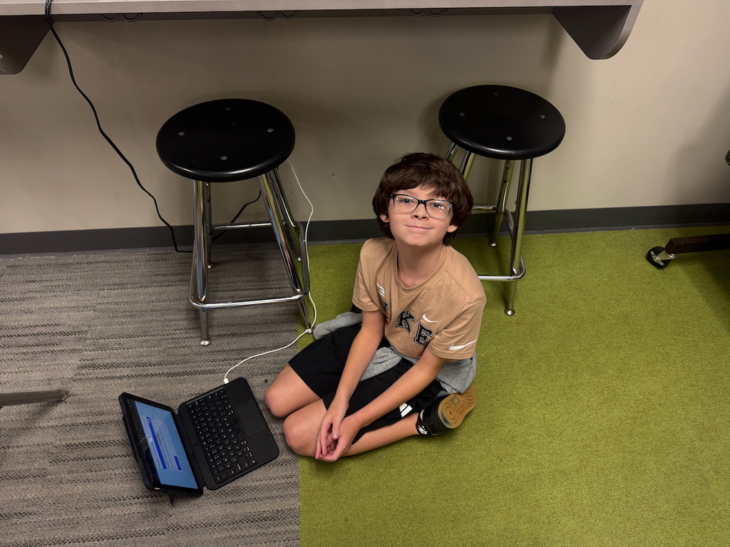 Student smiling with his laptop