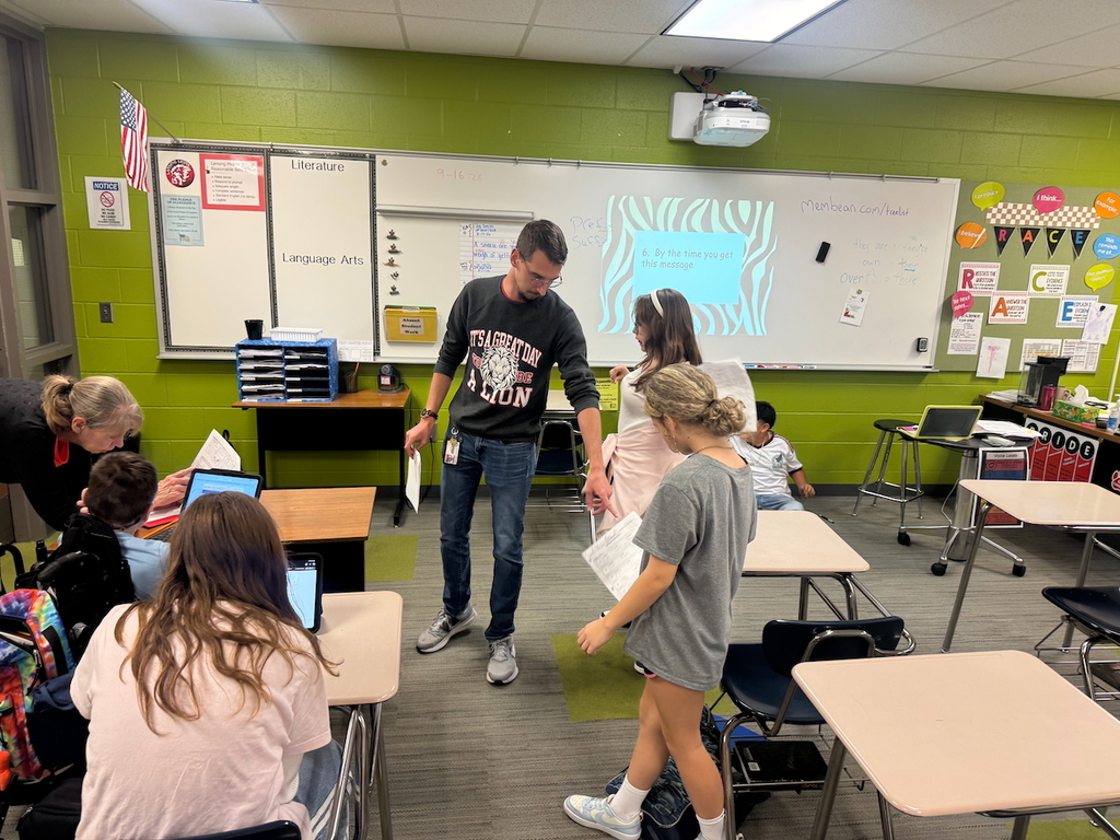 Teacher pointing to a problem on a student's paper