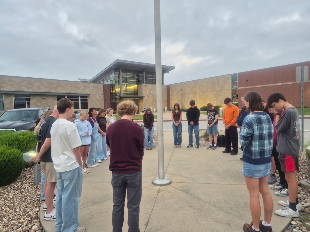 Students praying in front of high school