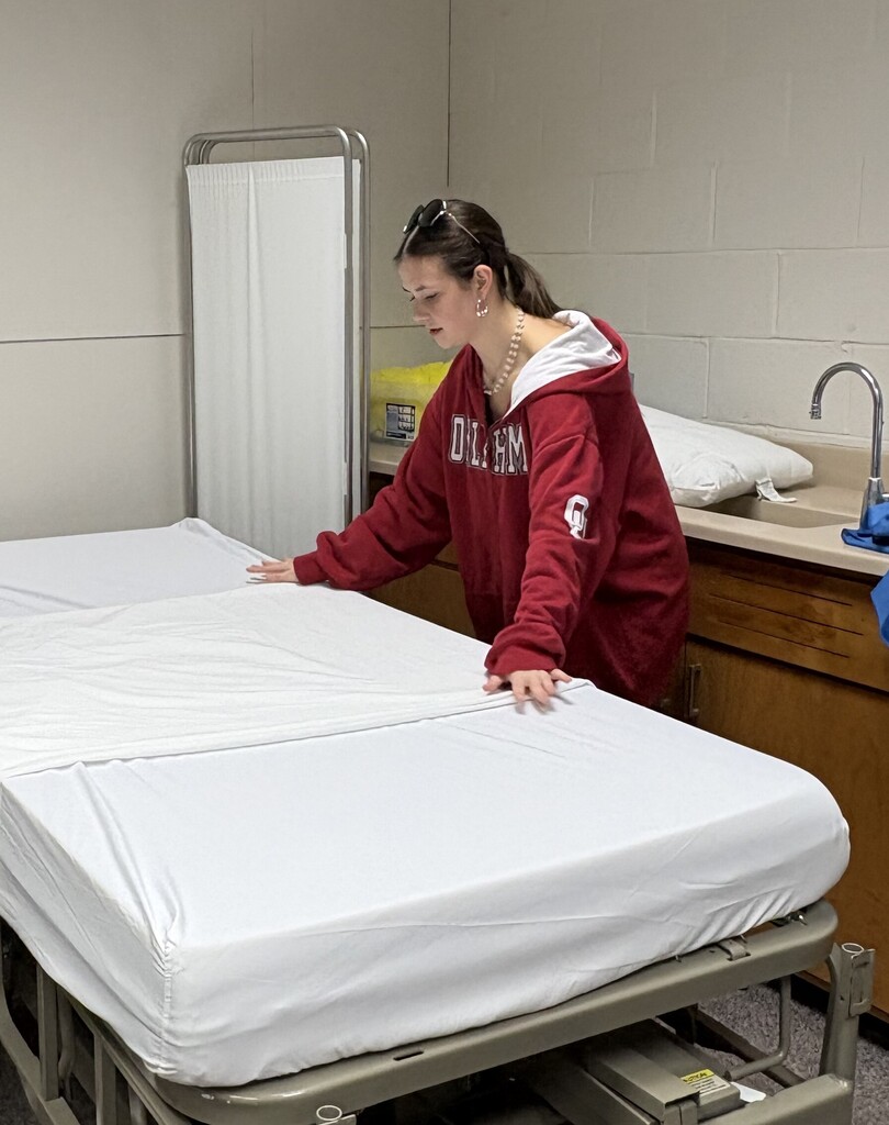 CNA Students learning hot to make occupied and unoccupied beds safely and efficiently